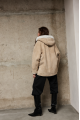 Stylish suede sheepskin coat made of natural sheepskin in beige color with a hood